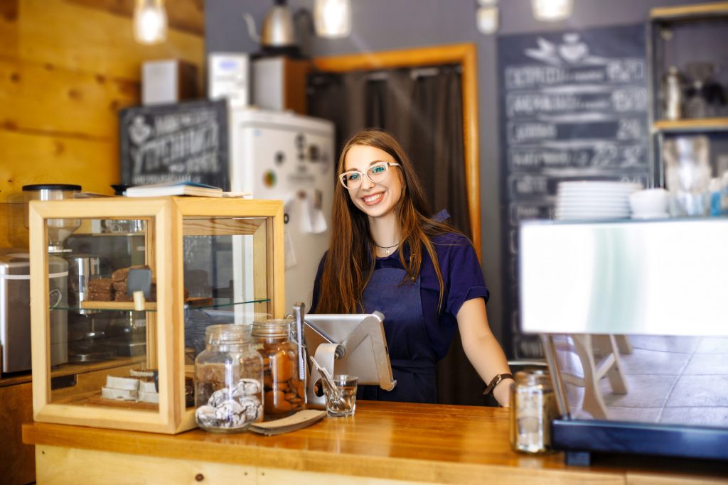 barista standing behind counter