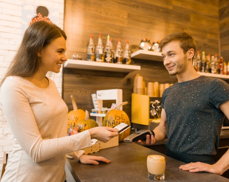 women paying with credit card